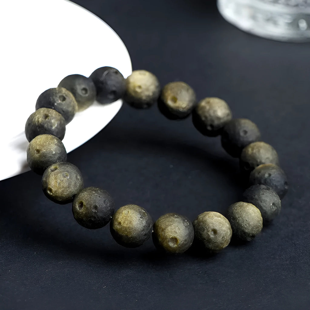 Obsidian crater ball bracelet in silver stone meteorite colour with textured round beads.