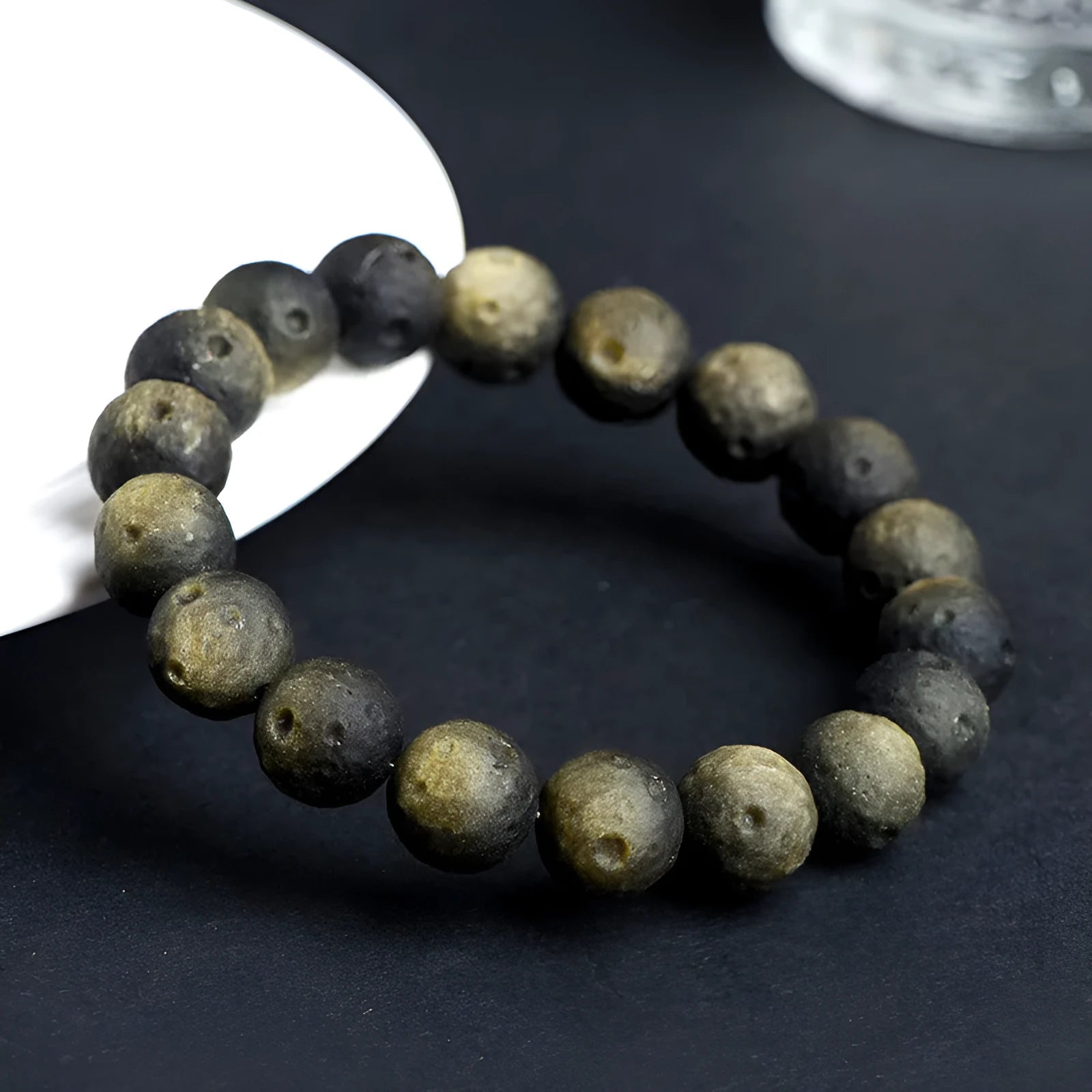 Obsidian crater ball bracelet in silver stone meteorite colour with textured round beads.