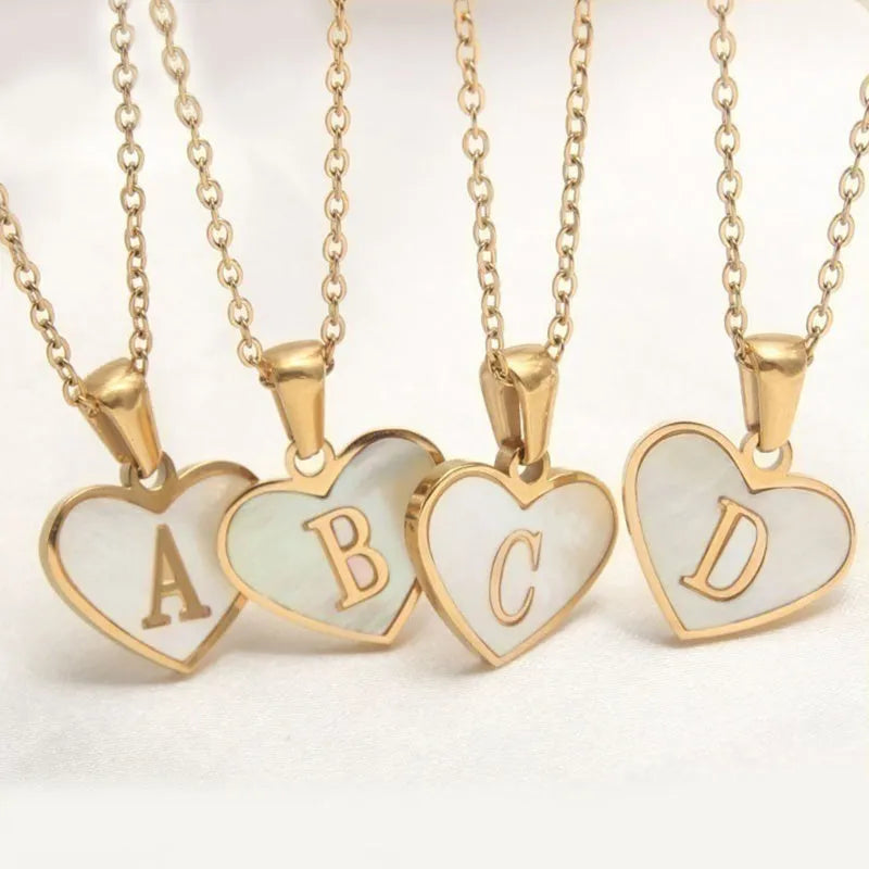 Gold heart necklace with white shell centre on stainless steel chain