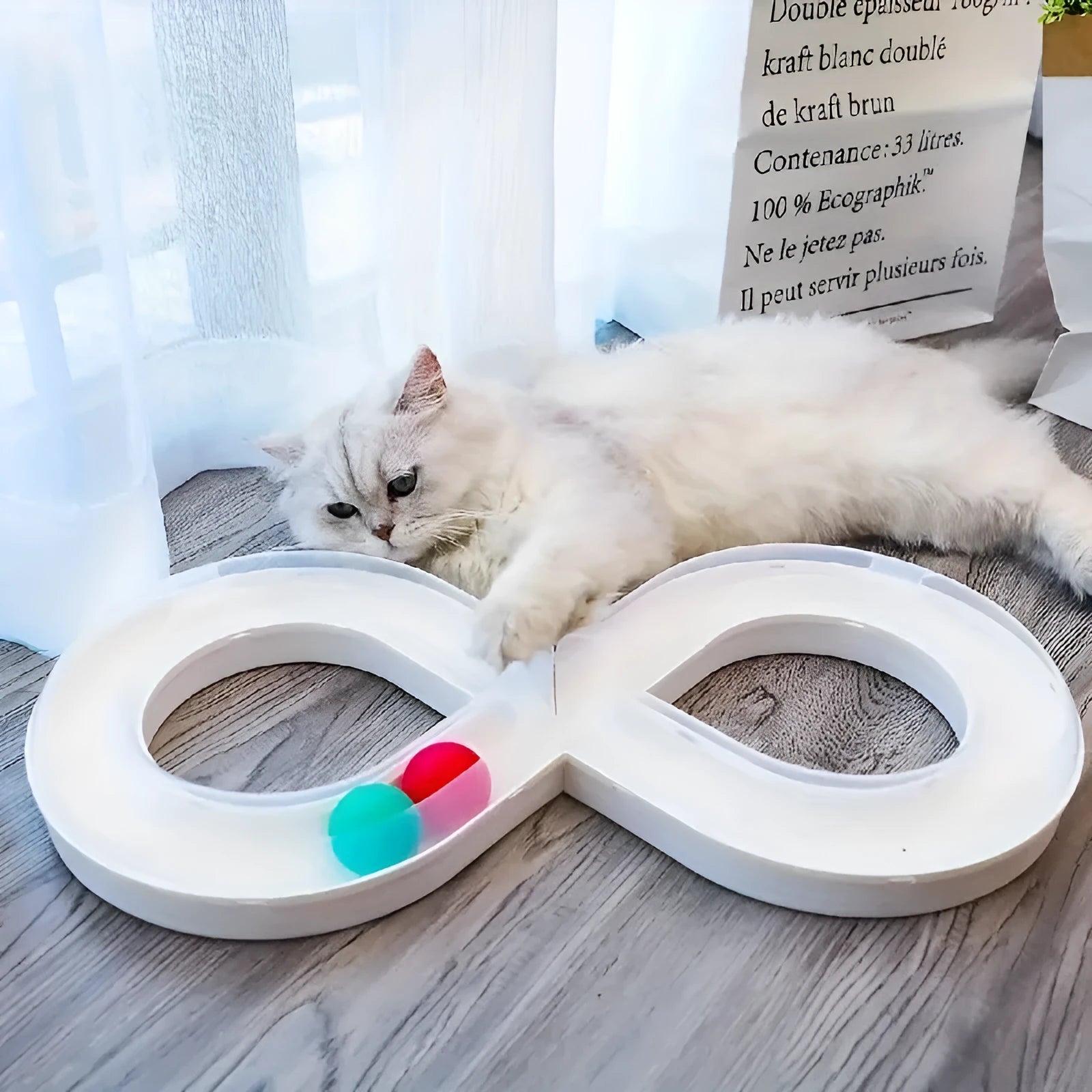 Blue and white plastic cat toy turntable track with a ball and a separate teasing stick.
