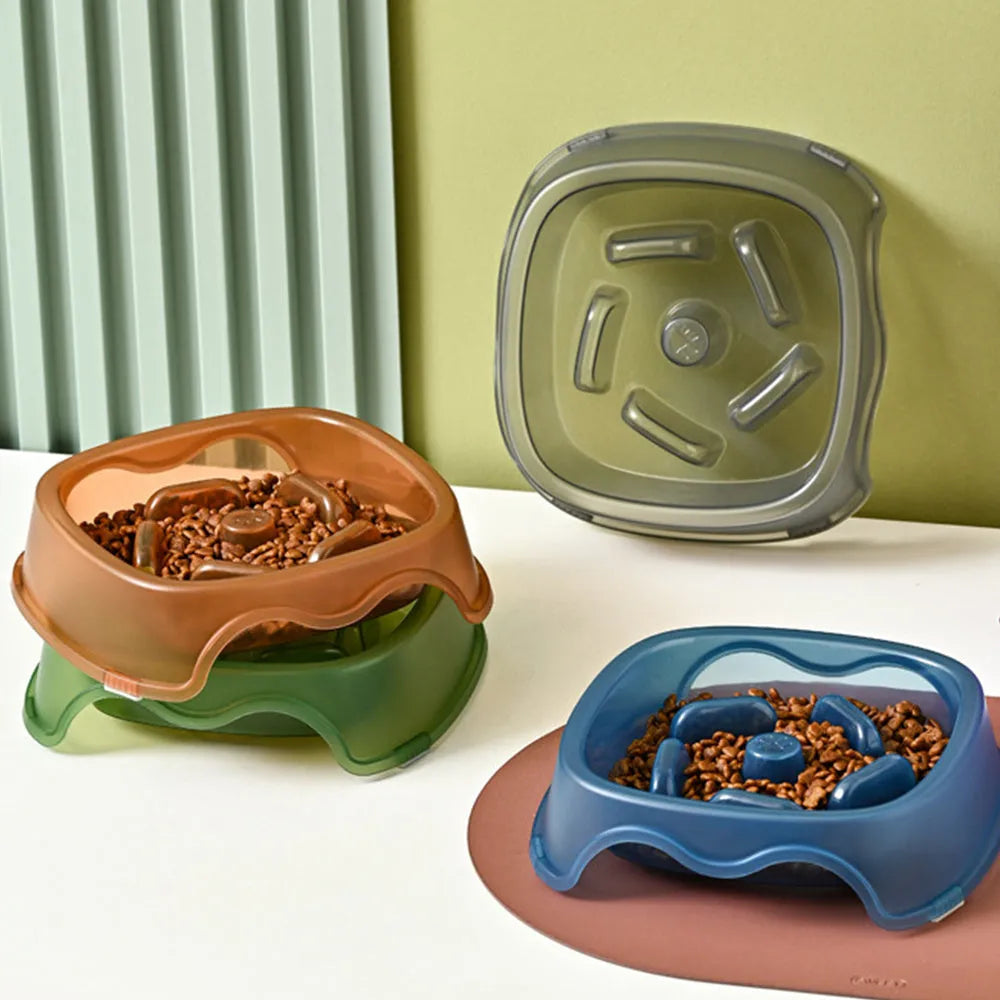 Blue plastic slow-feeder dog bowl on a wooden floor.