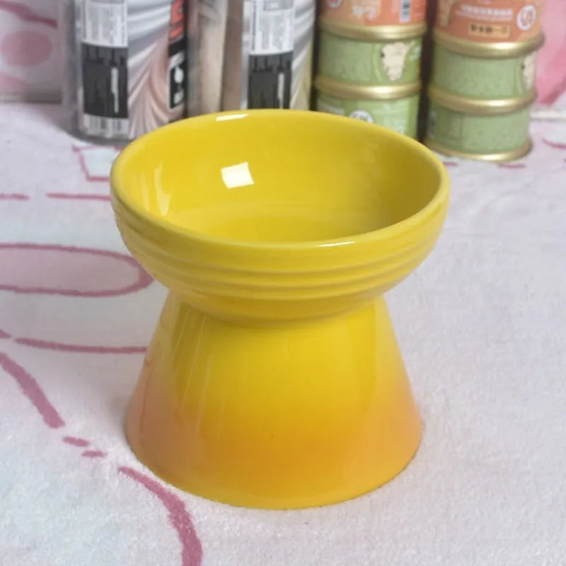 Ceramic anti-tumble pet bowl for dogs and cats with high foot and neck protector.