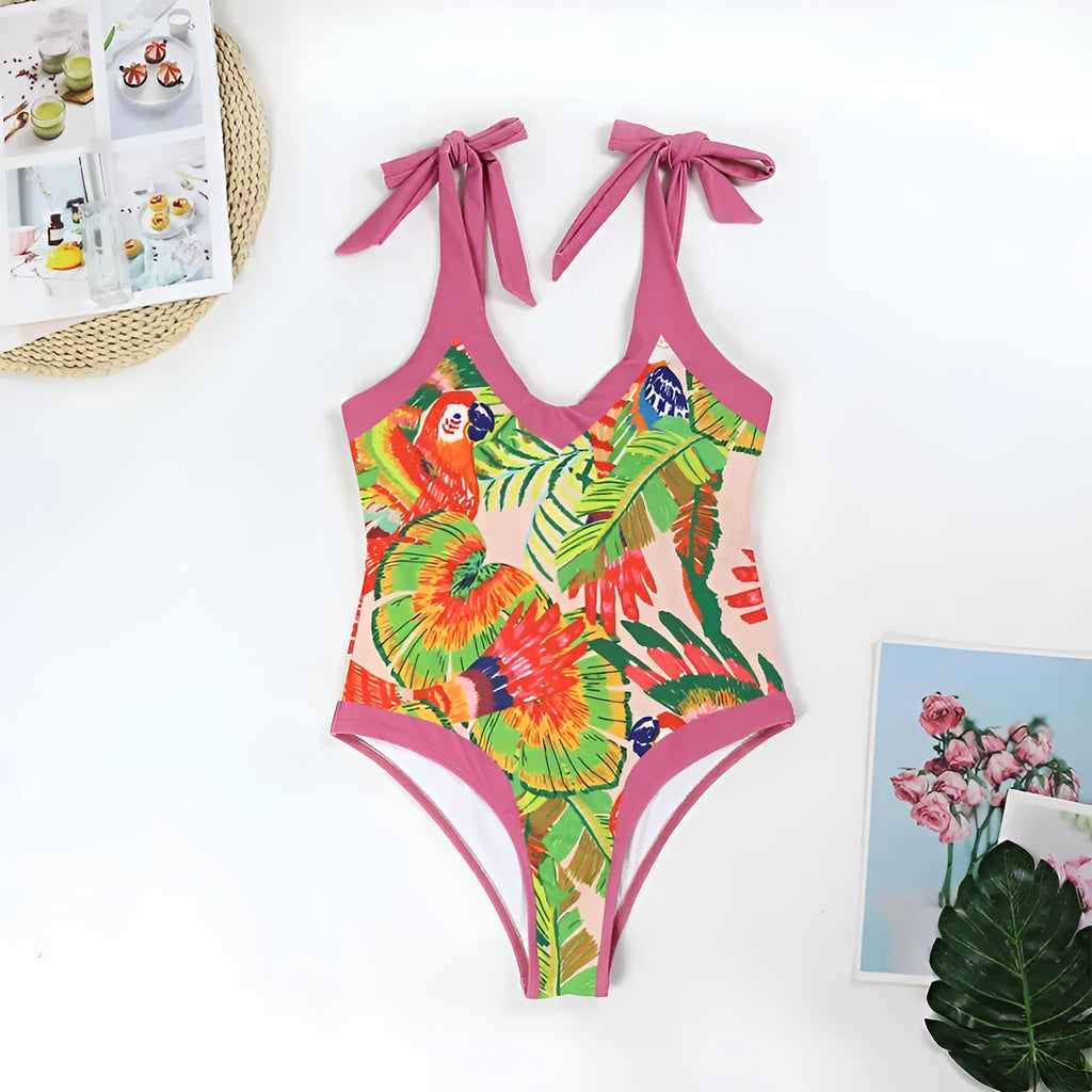 Retro pink floral print women's one-piece swimsuit with V-neck and attached thin skirt.