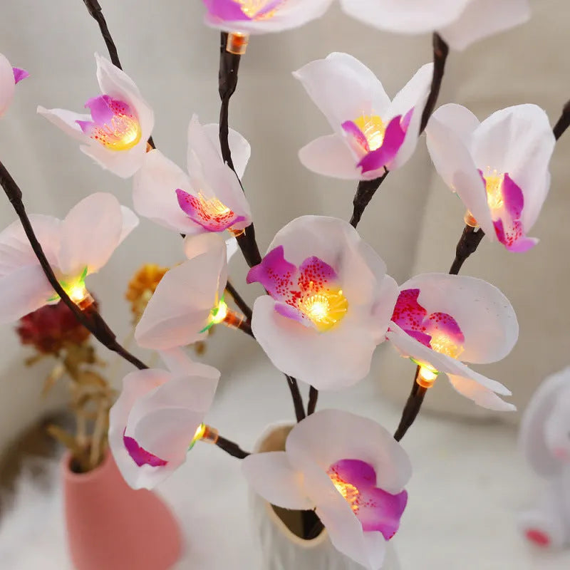 Pink LED phalaenopsis orchid branch decorative light, 65cm long with fabric blossoms.