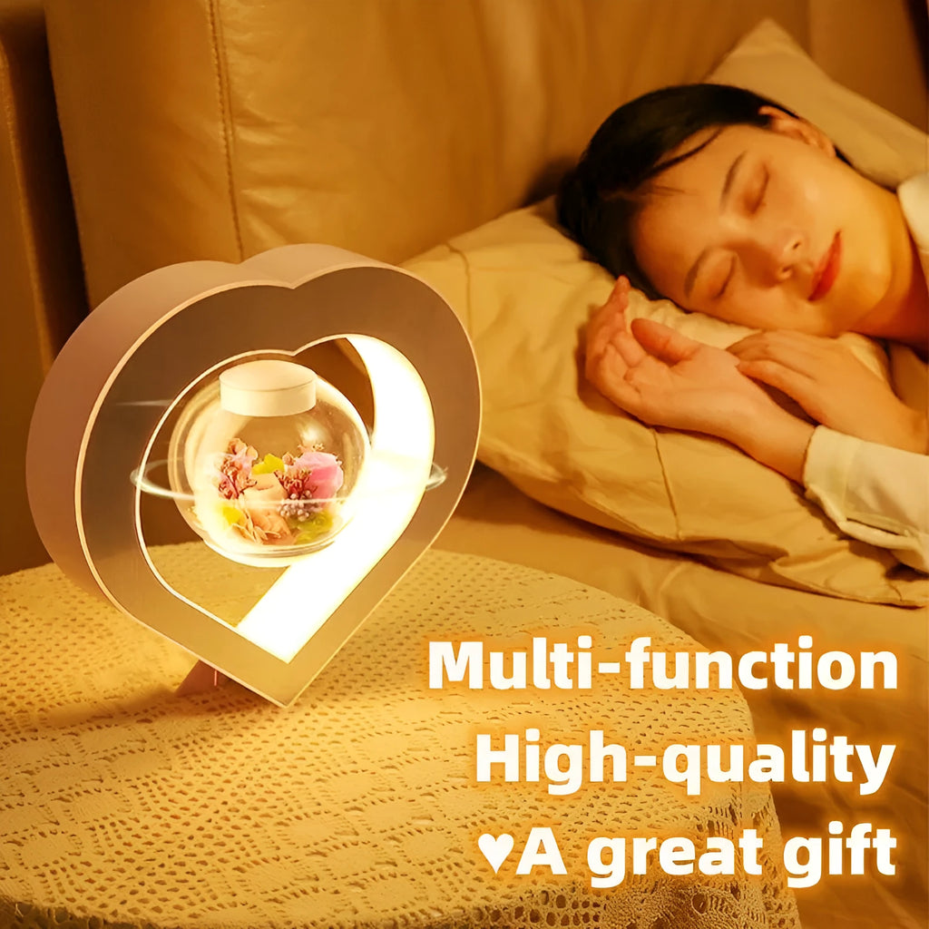 Magnetic levitation heart night light with pink eternal rose floating inside transparent sphere on triangular stand