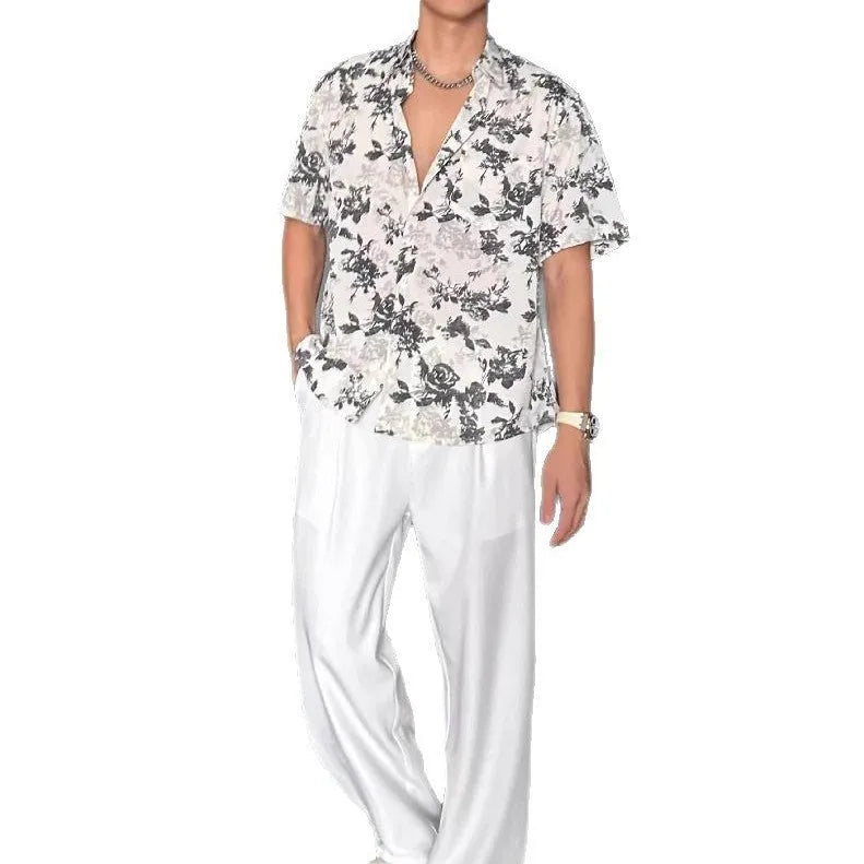 Loose black and white floral print short sleeve casual shirt on a hanger.