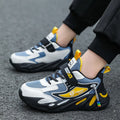 Boys' blue and black Velcro fastening sports running shoes on a white background.