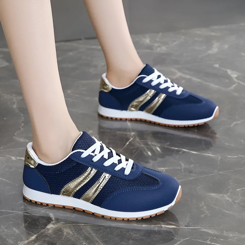 Blue women's casual tennis shoes with cross straps and white rubber sole