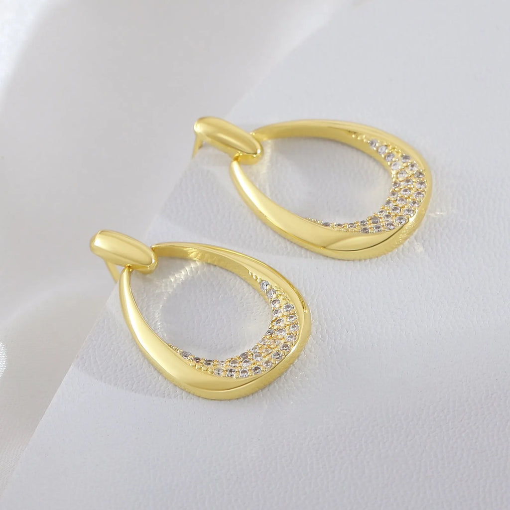 Women's yellow gold geometric drop earrings with oval rings measuring 2.6cm