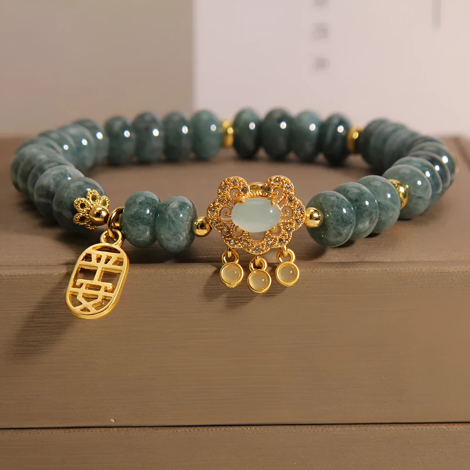 Natural emerald jade bracelet for women with abacus beads and a safety lock clasp on a white background.