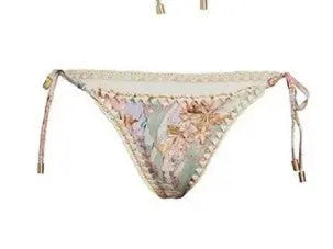 Women's creamy-white floral bikini set with halter top, briefs, and skirt