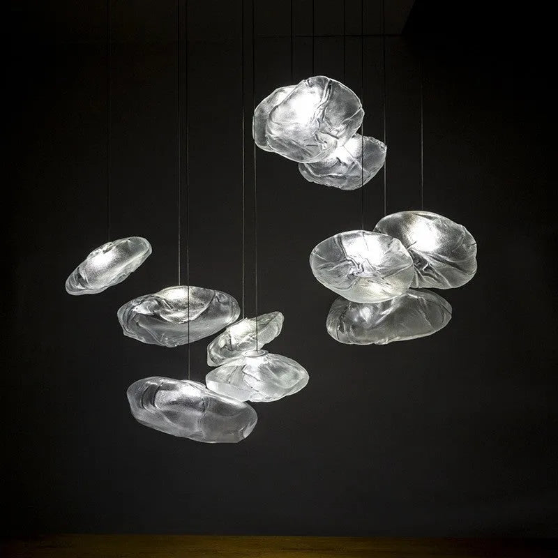 Modern decorative chandelier with glass shade and fabric design, available in amber, clear, or smoke grey.