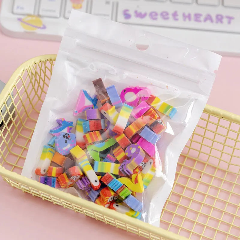 50 small colourful cartoon novelty erasers including fruit and animal shapes in a pearlescent film bag.