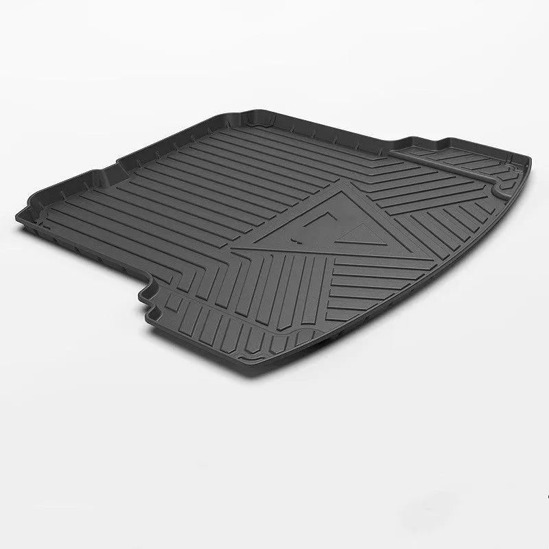 Black carbon fibre pattern TPE car boot liner mat fitted in a hatchback trunk.