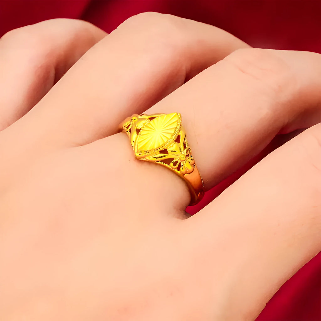Open geometric flower ring in gold colour with textured details on brass base