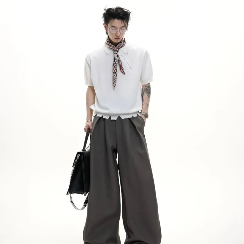 Man modelling a slim-fit black knitted polo shirt with an oblique diagonal zip closure and short sleeves.