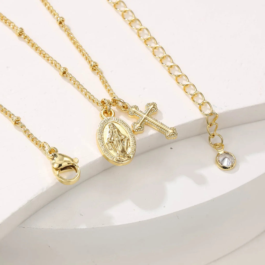 Virgin Mary geometric cross necklace in gold colour with 18k gold-plated copper construction
