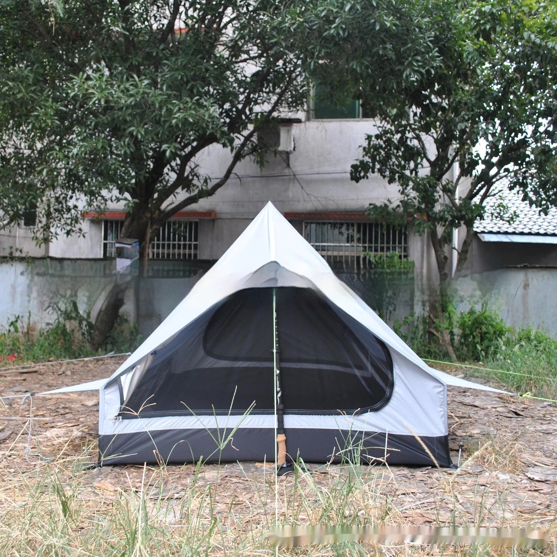 Brown A-line trekking tent pitched using hiking poles with dimensions 210x150x110cm