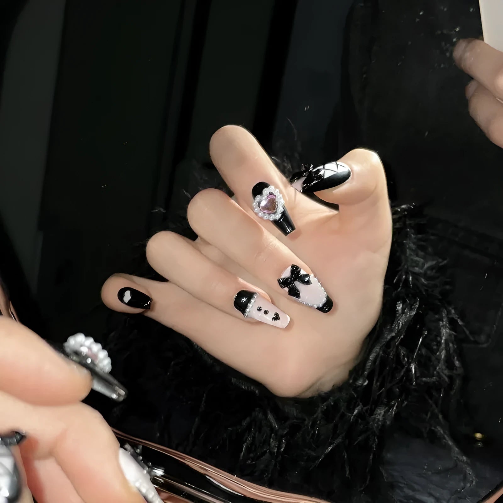 Black peach heart hand-painted artificial nails with cat's eye design in plastic storage case