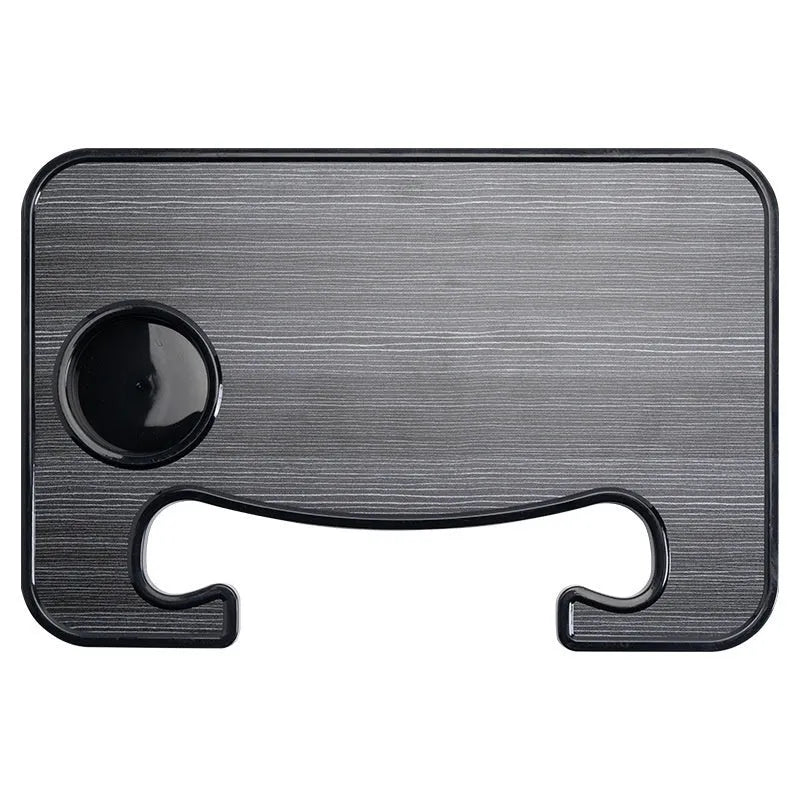 Black car steering wheel laptop tray mounted on vehicle steering wheel with laptop placed on surface