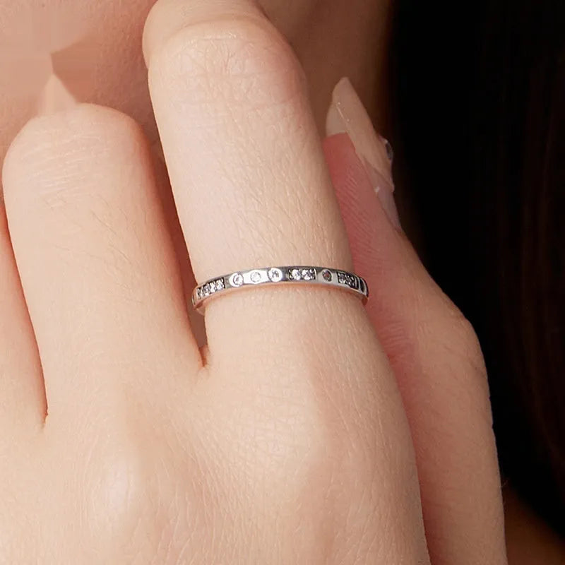Silver alloy Moss Password I Love You ring with black oxidation treatment on a model's finger.