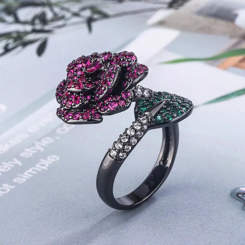 Geometric black gold women's ring with simulated red corundum stone and flower design elements