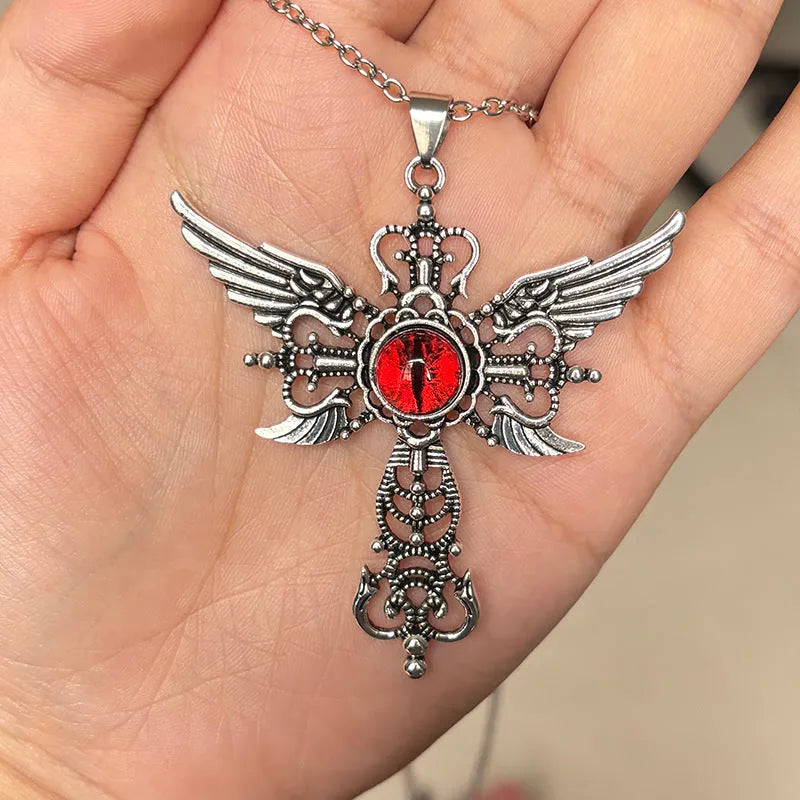Close-up of a blue alloy necklace featuring a geometric cross pendant with detailed devil wings.