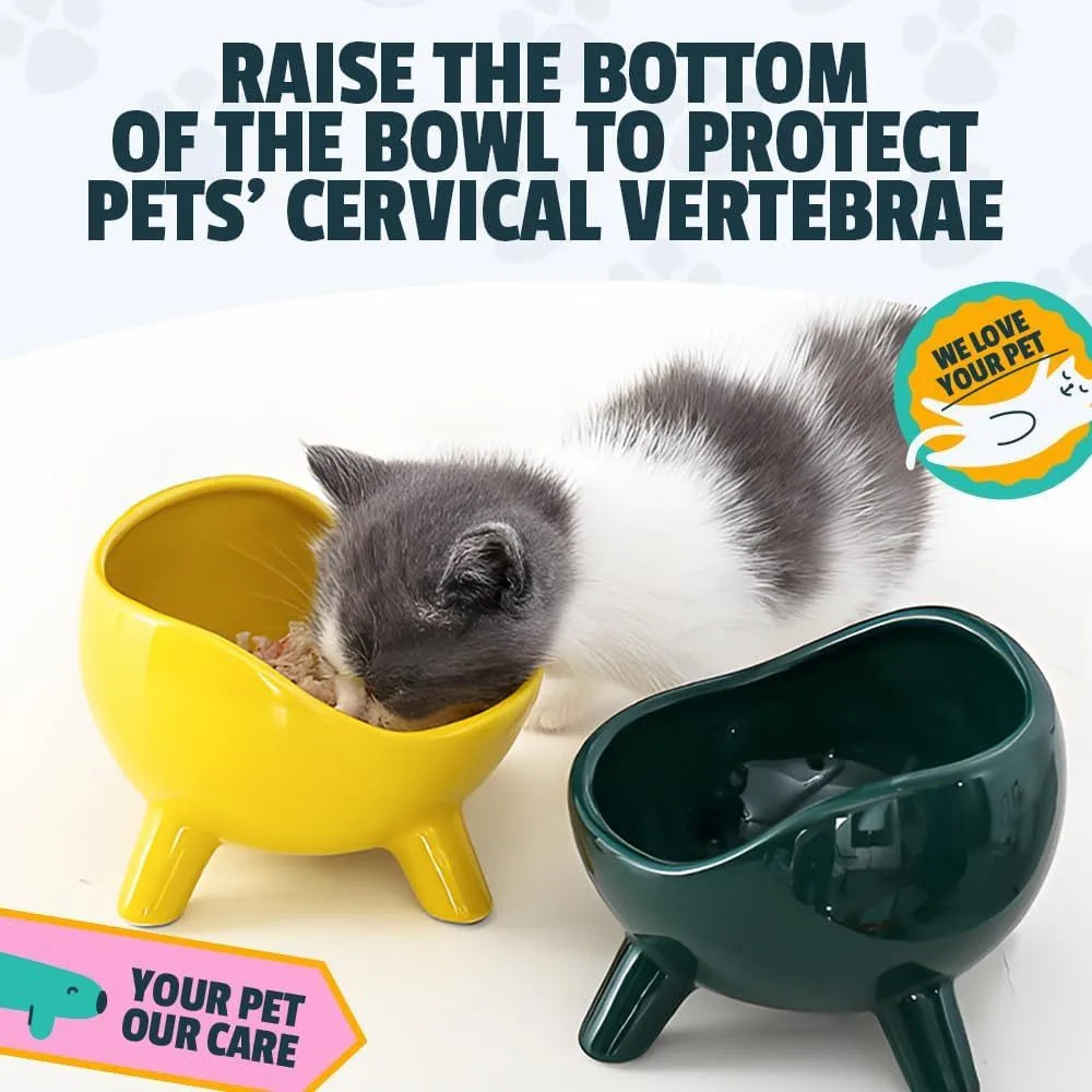 Green ceramic cat food bowl with four legs, wide mouth, and rounded arc shape on a light floor