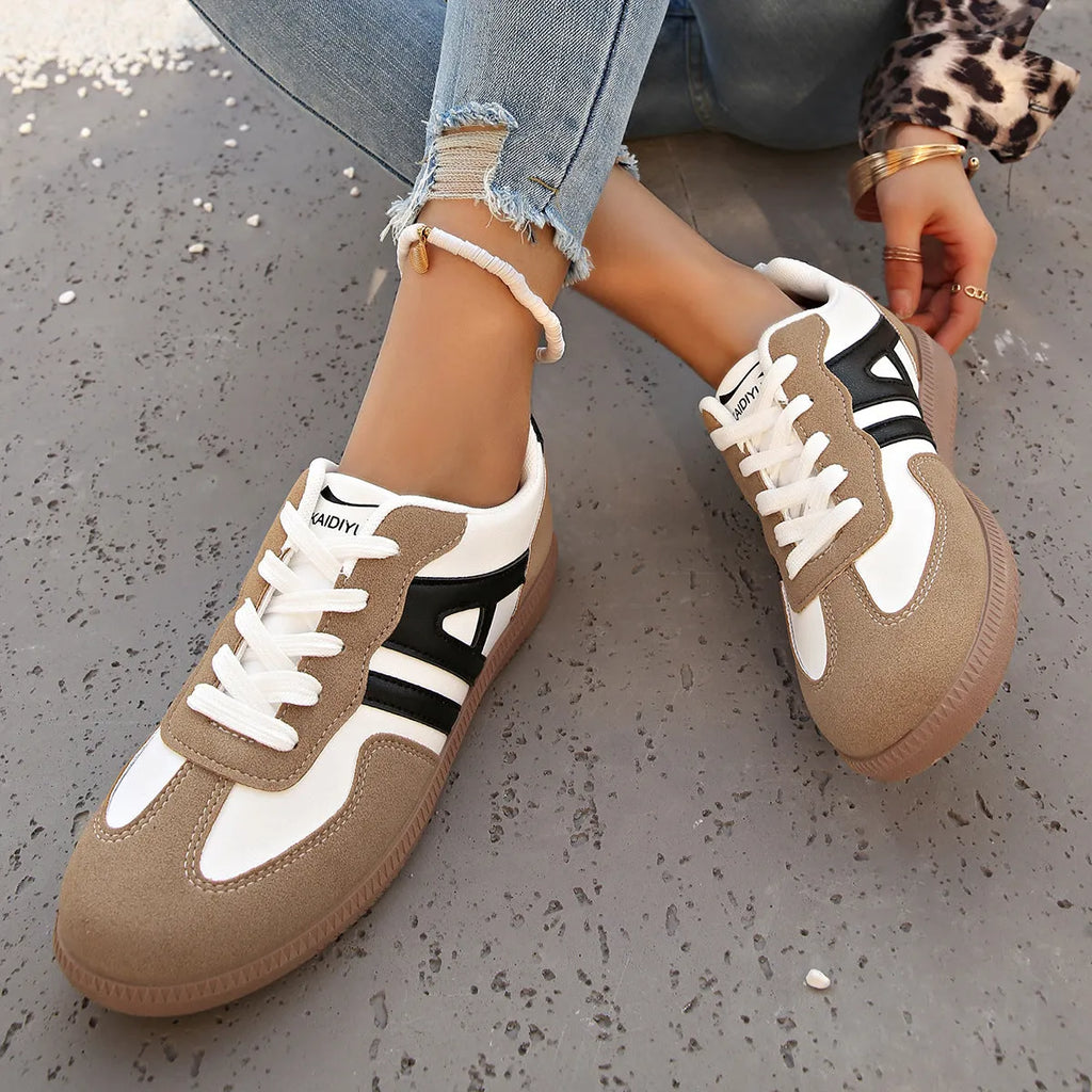 Retro colour-matching lace-up lightweight women's jogging shoes in black, side view showing low top and platform sole
