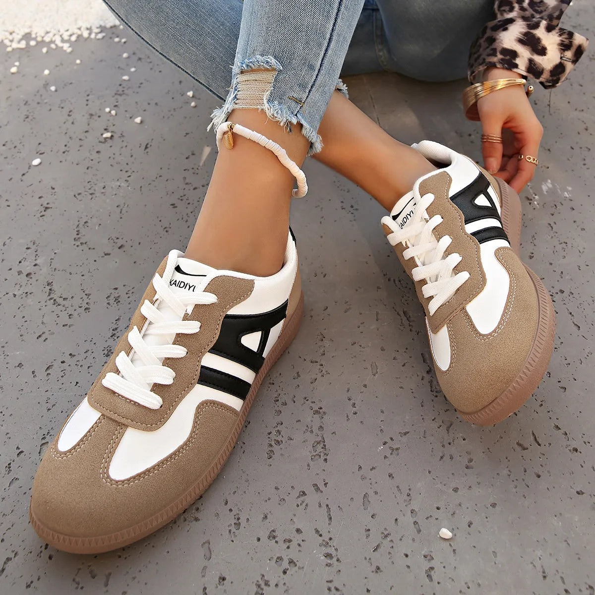 Retro colour-matching lace-up lightweight women's jogging shoes in black, side view showing low top and platform sole