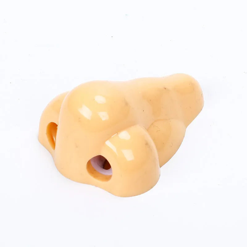 Flesh colour plastic pencil sharpener showing geometry design and large nostril hole