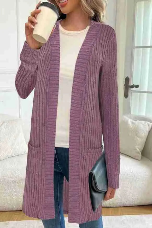 Black oversized knitted cardigan jacket with long sleeves and loose pockets.