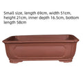 Large rectangular purple clay flowerpot for bonsai or garden plants on a patio.