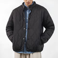 Men's black diamond lattice pattern winter jacket showing lengthened cut and medium thickness