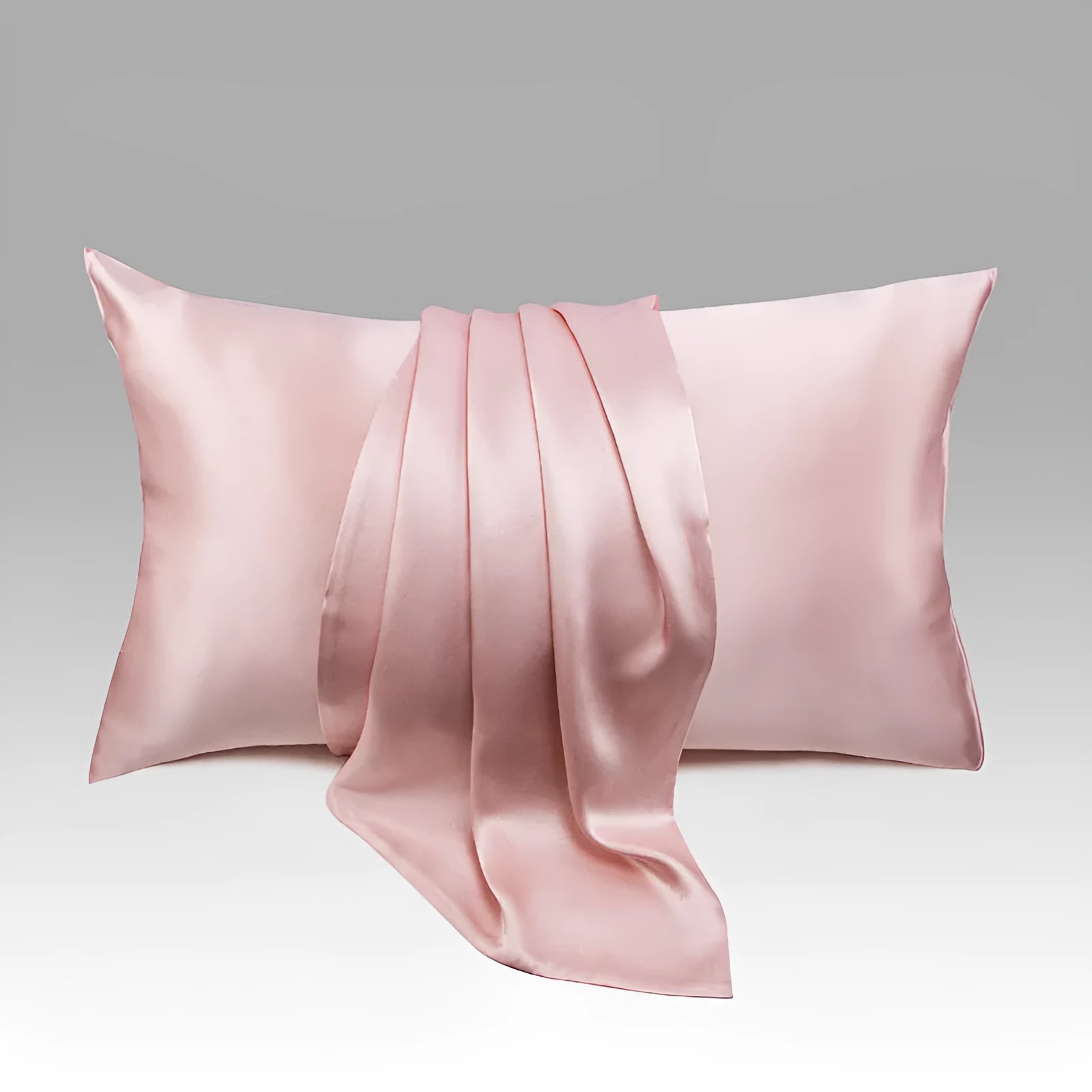 Dark gray 19 M silk envelope pillowcase with envelope closure on a bed.