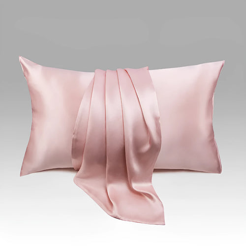 Dark gray 19 M silk envelope pillowcase with envelope closure on a bed.