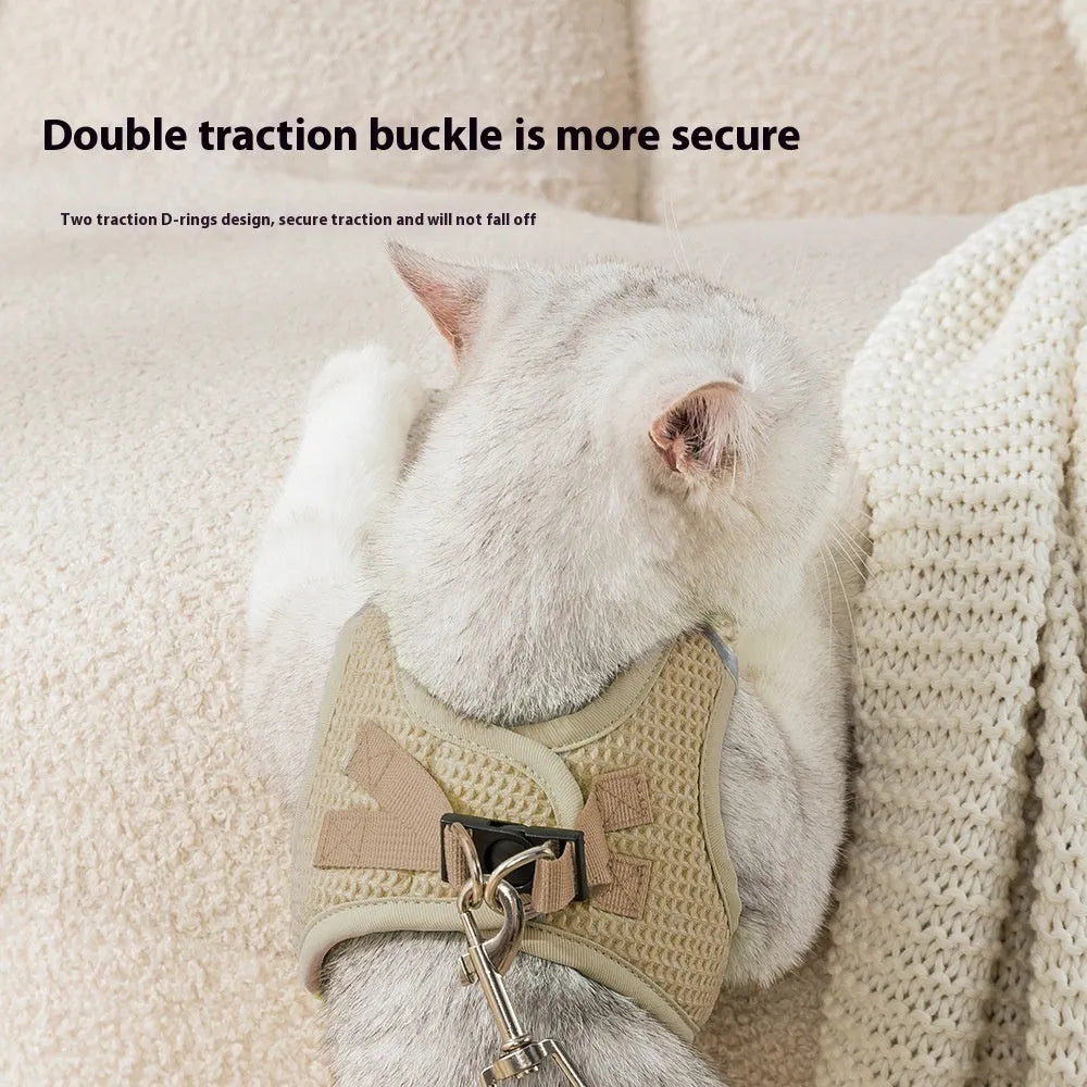 Brown cloth cat harness with chest strap and hand holding rope showing waffle texture pattern