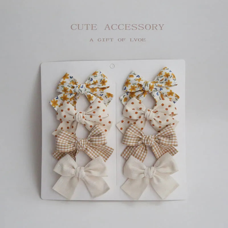 Children's cloth bow hairclips in eight-piece set with dovetail design