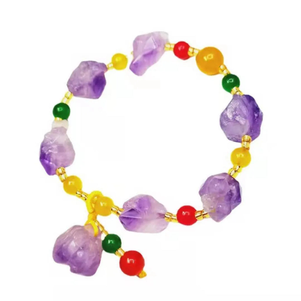 Natural shaped purple amethyst bead bracelet with a silver fu charm on an adjustable knotted cord.