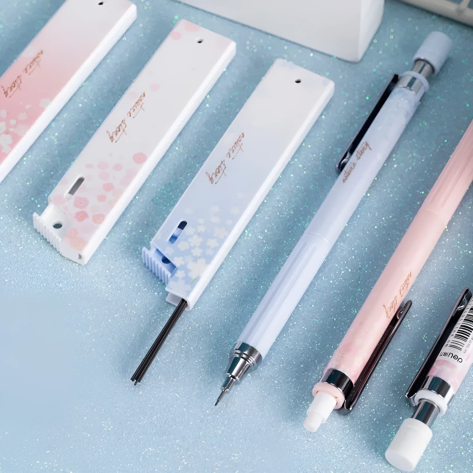 Set of three cartoon-style 0.5mm automatic pencils and boxes of HB lead refills.