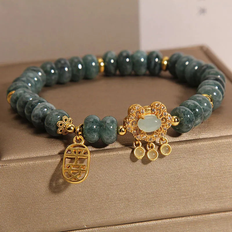 Natural emerald jade bracelet for women with abacus beads and a safety lock clasp on a white background.