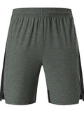 Man wearing forest green five-point spandex casual shorts with a mid waist.