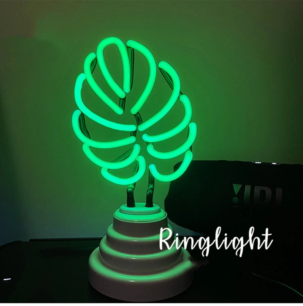 Minimalist bamboo-shaped desktop lamp with green light in white tube, showing large and small size options