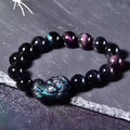 Natural ice colour eye obsidian crystal bracelet on wrist showing bead size.
