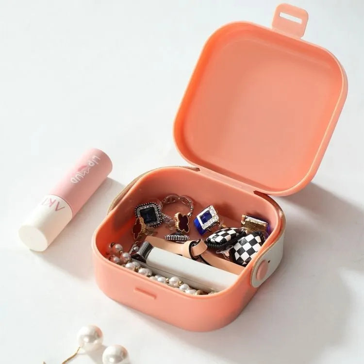 Medium-sized polypropylene storage box with a lid for organising cables and a Bluetooth headset.