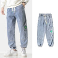 Men's cotton loose-fit tapered trousers in black colour showing mid-waist design and tapered leg silhouette