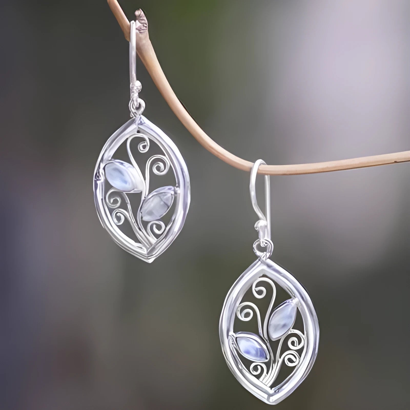 Silver leaf-shaped earrings with embedded colourful moonstone stones, European design