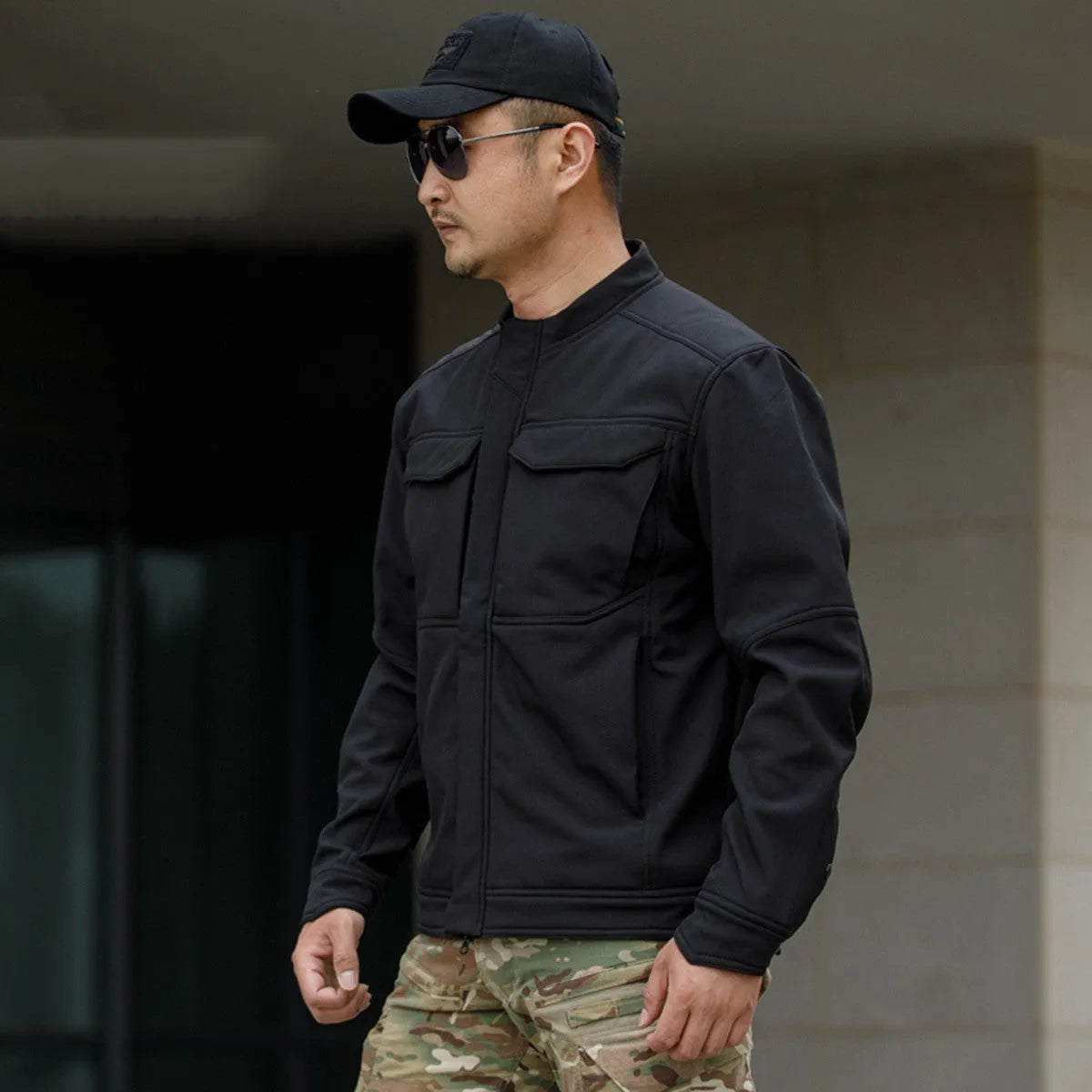 Black soft shell tactical jacket for mountaineering and camping, showing cardigan style and windproof design.