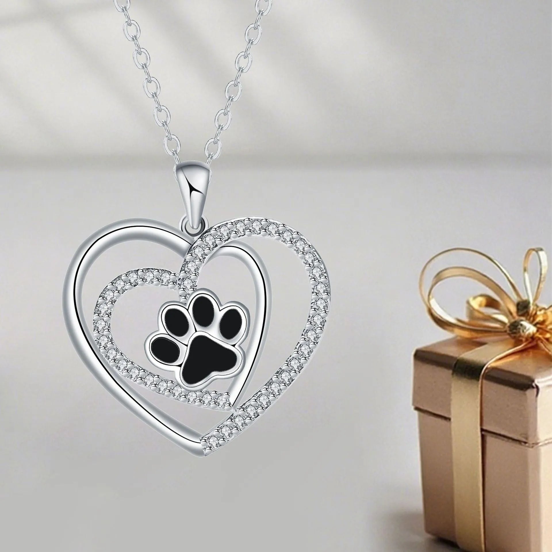 Electroplated copper necklace with heart-shaped dog paw print pendant on cross chain
