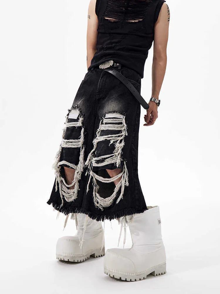 Black wide-leg cropped jeans with ripped patch detailing and mid-high waist